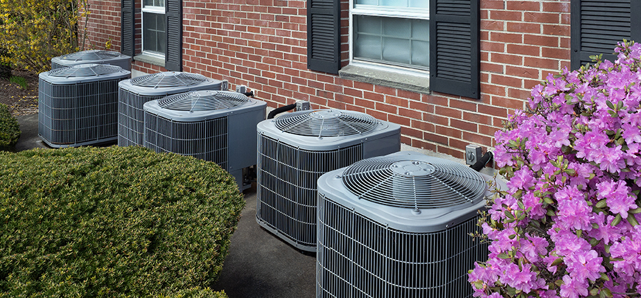 row of AC units in front of rental property